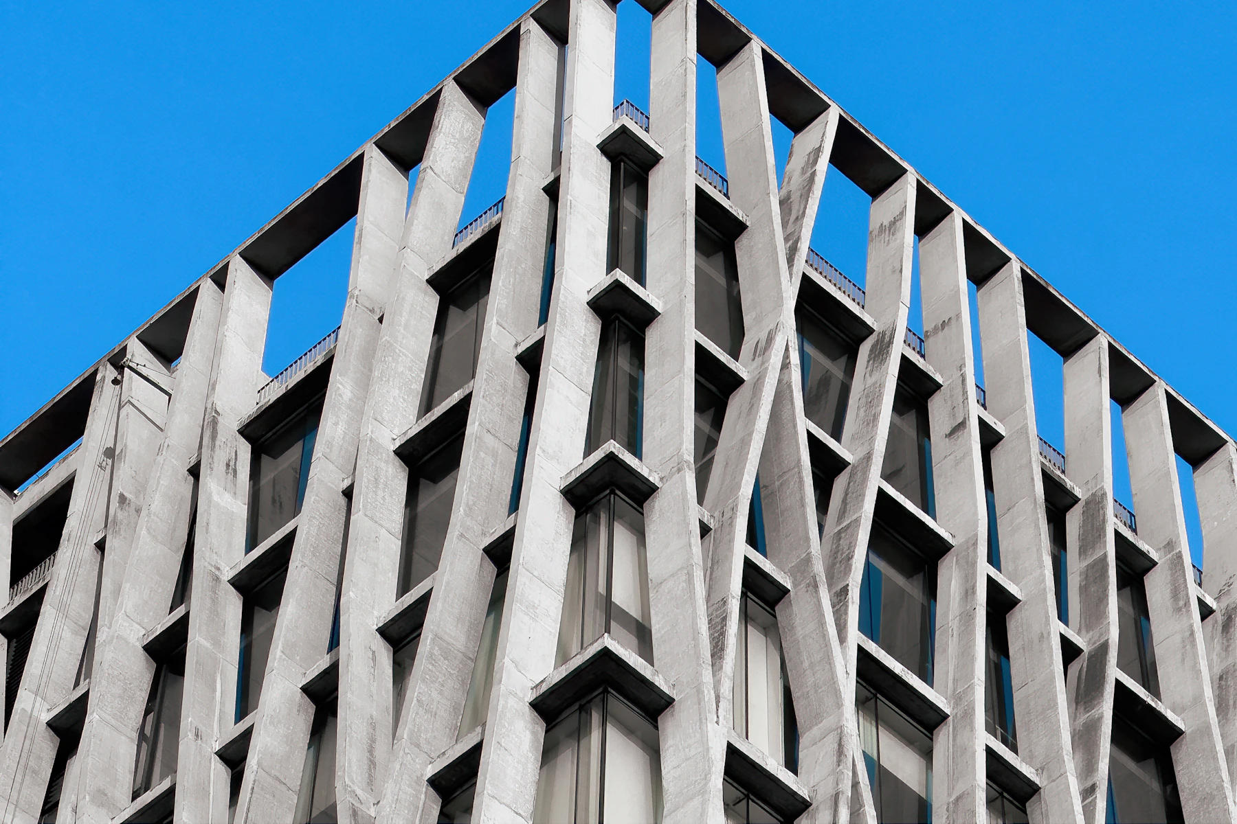 Concrete architecture rising into a clear blue sky