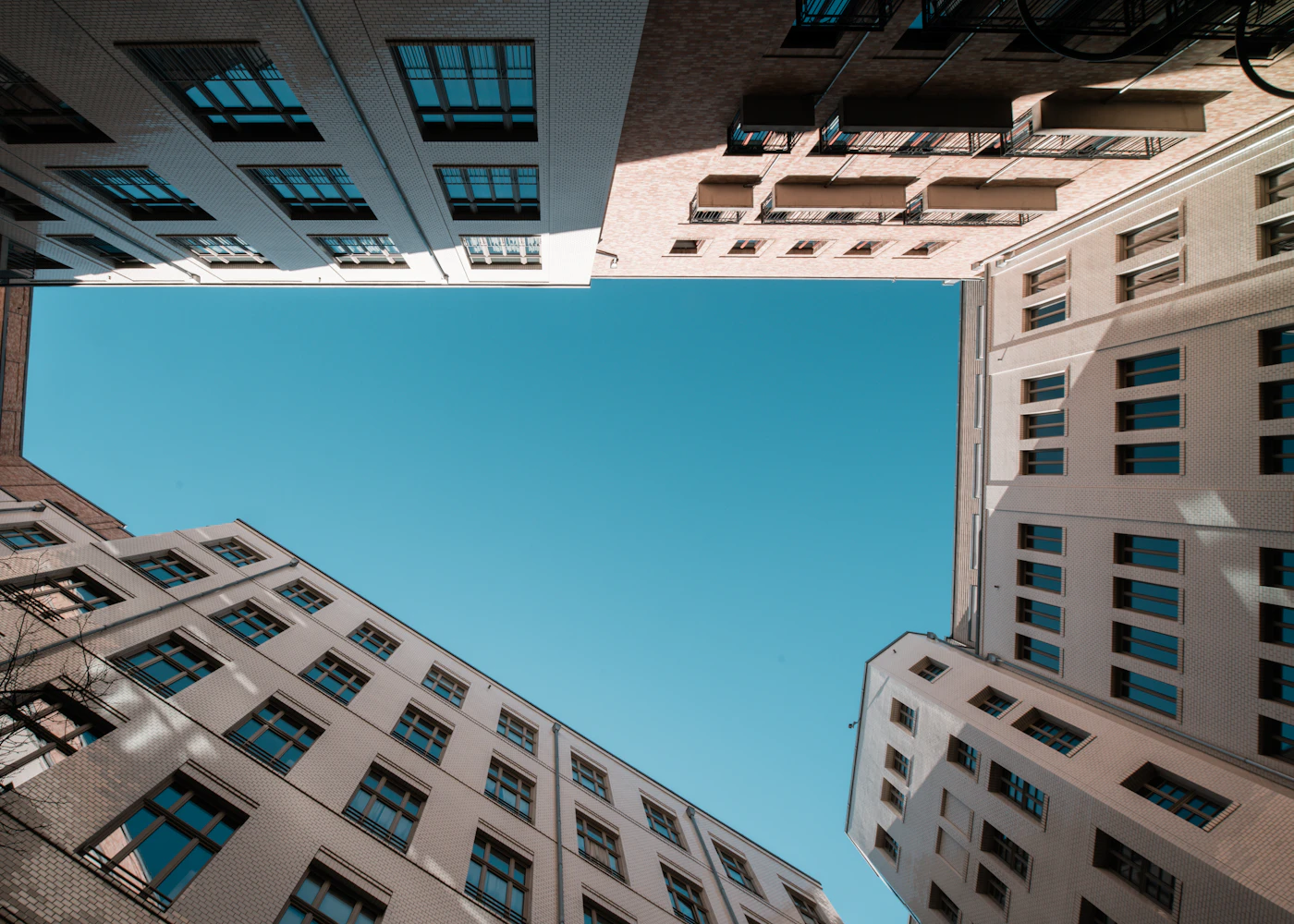 A geometric courtyard framing a clear blue sky